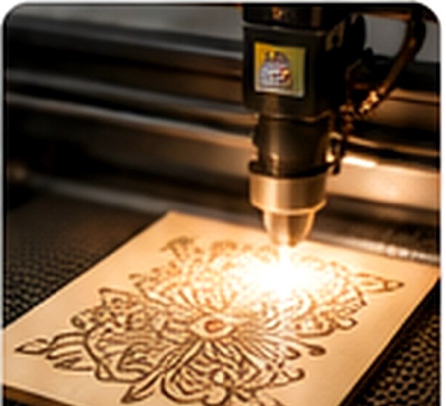 A learner safely operating a laser cutter to engrave an intricate design into wood
